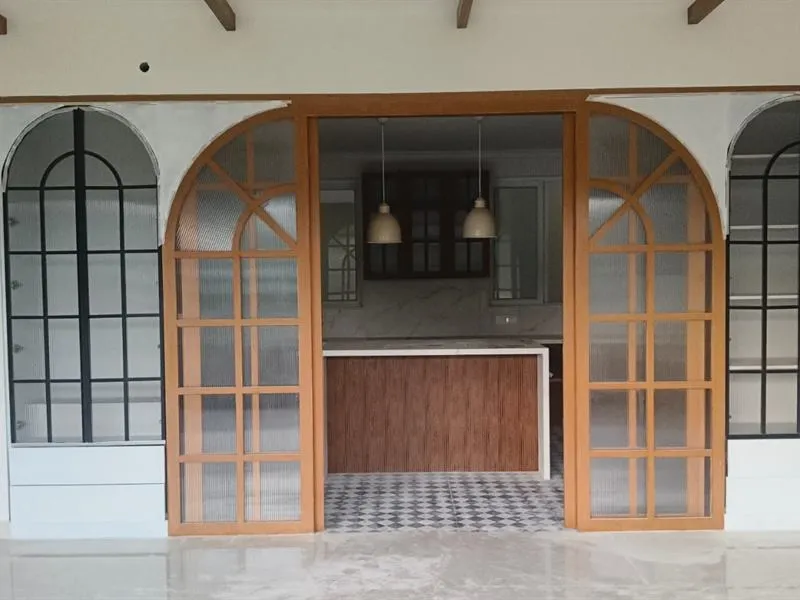 Home living area with arched glass doors opening to the kitchen