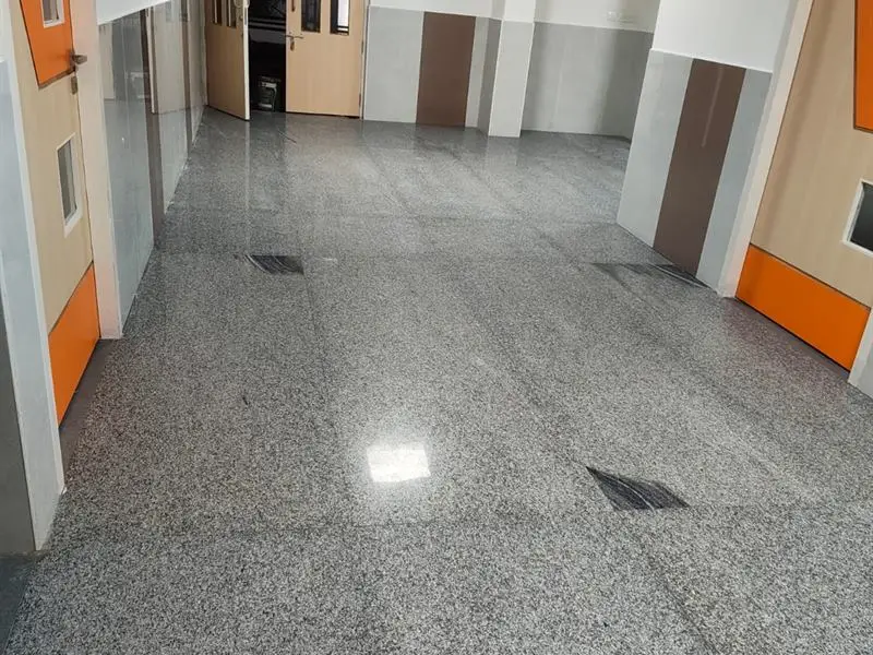 Empty hall with a polished granite floor in a newly finished building