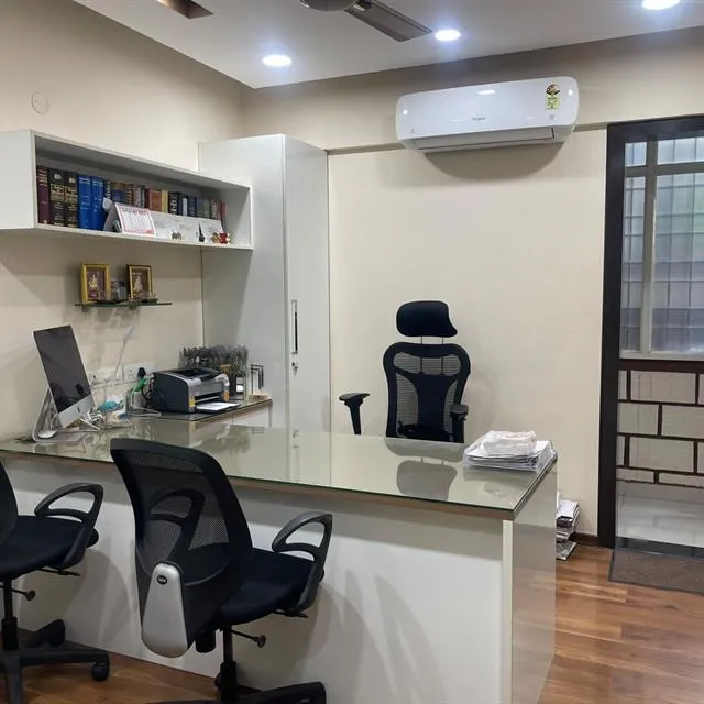 Office cabin with glass-top desk, chairs and wooden floor after cleaning
